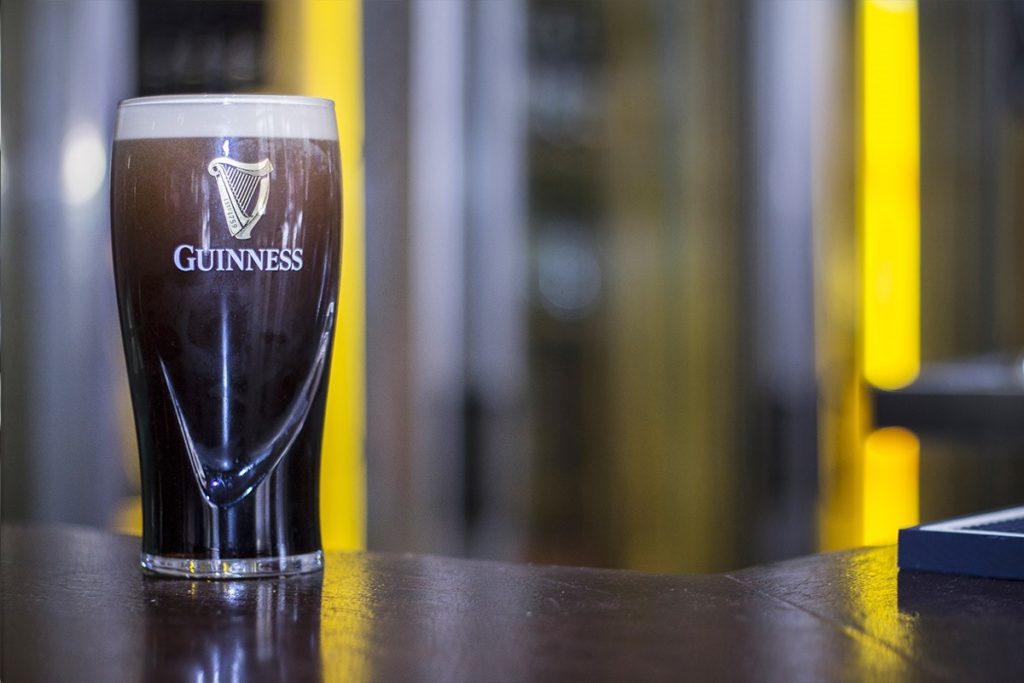 A filled Guinness on a bar table.