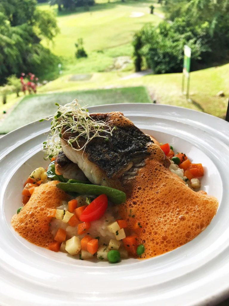 A fish dish served with a tomato foam.